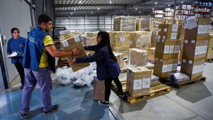 Workers load ballot boxes and voting material into a truck, ahead of the presidential election, in Buenos Aires, on 21 October 2023 | Reuters