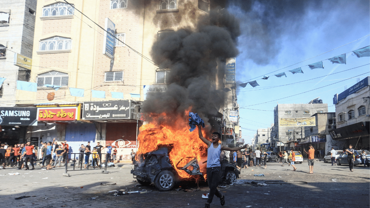 A burning Israeli vehicle that Palestinian gunmen brought to Gaza after they infiltrated areas of southern Israel, in the northern Gaza Strip Saturday| Reuters/Mahmoud Issa