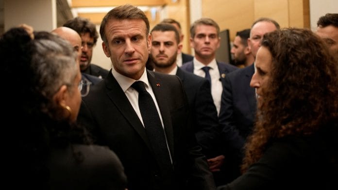 French President Emmanuel Macron meets with Israeli-French nationals who have lost loved ones, as well as families of hostages, at the Ben Gurion airport in Tel Aviv, on 24 October | Christophe Ena/Pool via Reuters