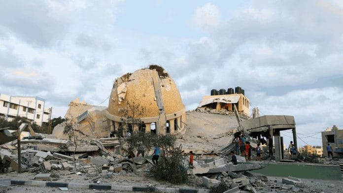 Palestinians inspect a mosque destroyed in Israeli strikes in Khan Younis, southern Gaza Strip, Sunday | Reuters