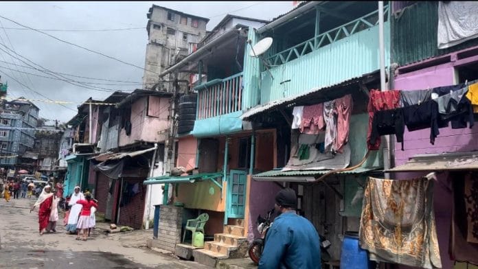 A view of the closed-off lane crowded with people and parked vehicles | Photo: Monami Gogoi, ThePrint
