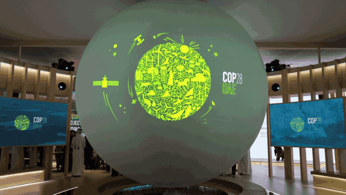 The Cop28 UAE logo on a globe during Abu Dhabi Sustainability Week in Abu Dhabi, UAE, 17 January | Reuters