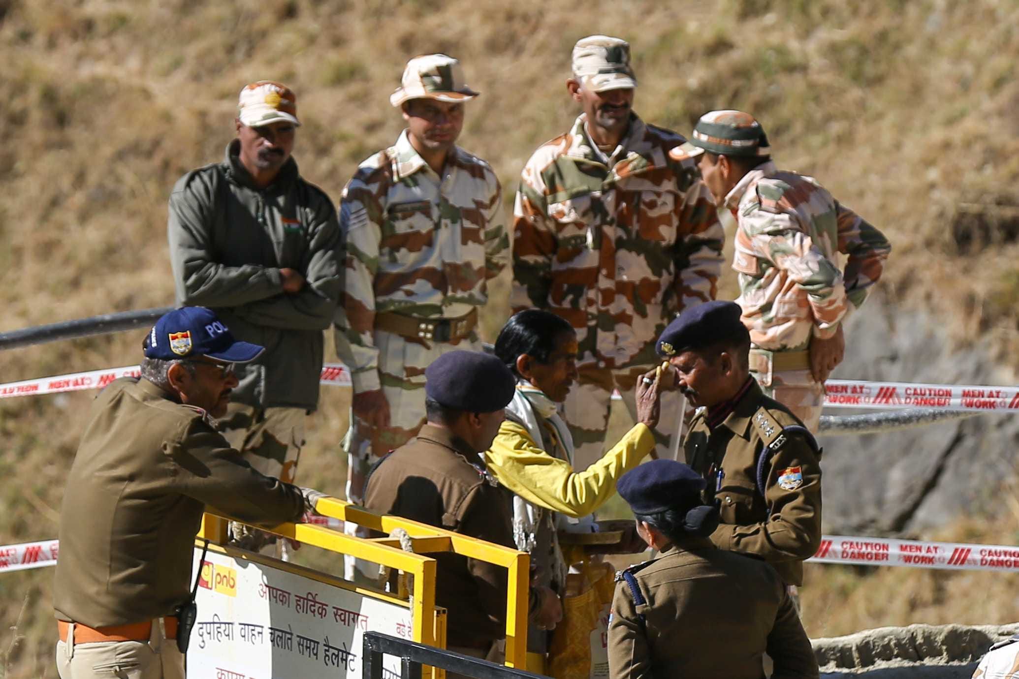 A priest applies 'tilak' to people involved in rescue of workers trapped inside the collapsed tunnel | Suraj Singh Bisht | ThePrint