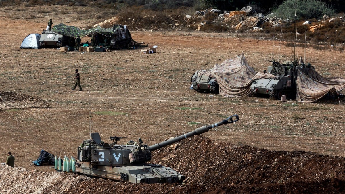 An Israeli tank & military vehicles near Israel's border with Lebanon on 9 Oct 2023 | Reuters/Ammar Awad