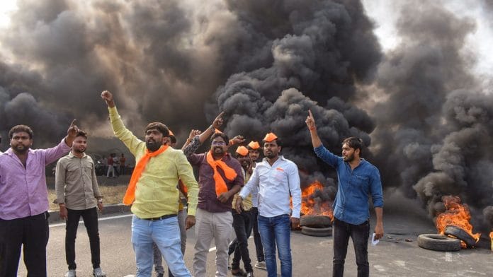 Maratha Kranti Morcha activists burn tyres and other inflamable items during a protest on Pune-Solapur Highway to press for Maratha reservation, in Solapur, on 1 November 2023 | PTI