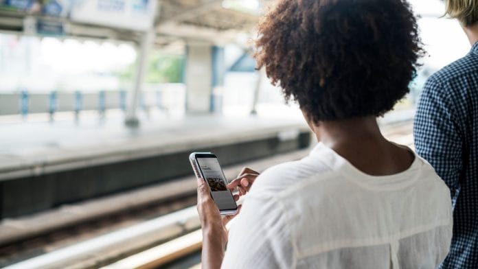 Woman waiting and playing on her phone | Representational image via pxhere