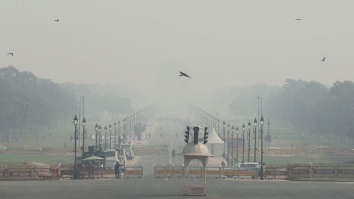 People walk on 'Kartavya Path' amidst the morning smog as air pollution levels declined in New Delhi on Monday | REUTERS/Anushree Fadnavis