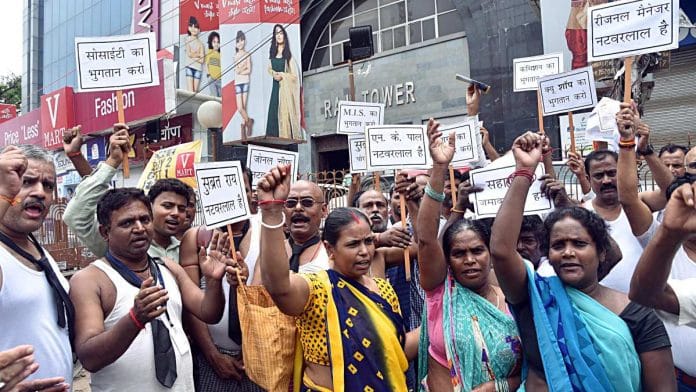 Employees and Investors shout slogans outside the Sahara India Pariwar office during a 2019 protest in Patna against Sahara India Pariwar Chairman Subrata Roy | ANI