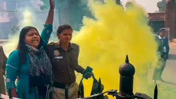 A policewoman apprehends Neelam Azad outside Parliament premises Wednesday | Photo: PTI