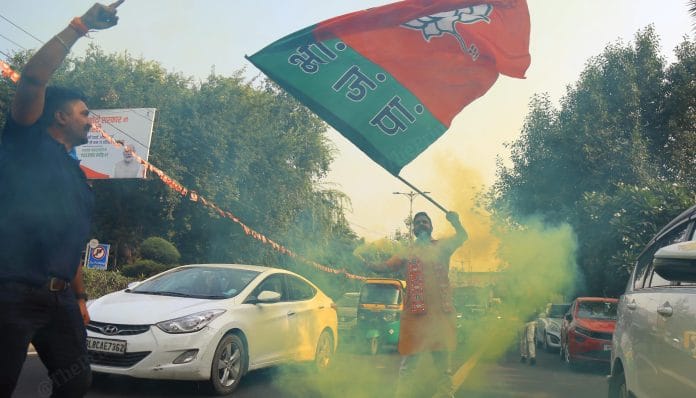 A BJP supporter celebrates after the party's victory in Madhya Pradesh, Rajasthan and Chhattisgarh | Suraj Singh Bisht | ThePrint