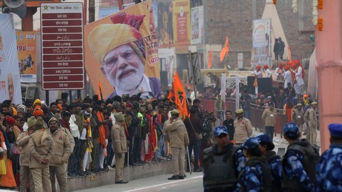 People standing in a footpath to welcome PM Narendra Modi | Photo: Suraj Singh Bisht | ThePrint