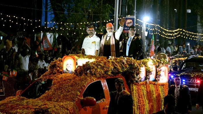 Prime Minister Narendra Modi waves to the supporters during a roadshow, in Kochi on Tuesday | ANI Photo