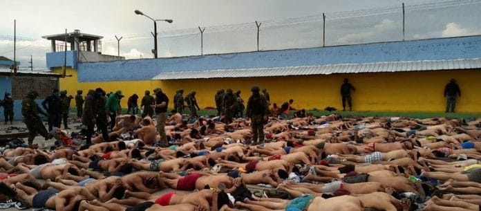 Inmates lie on the floor after Ecuador's police and armed forces freed prison staff members who had been held hostage by the prisoners, in Ambato, Ecuador | Armed Forces of Ecuador via Reuters