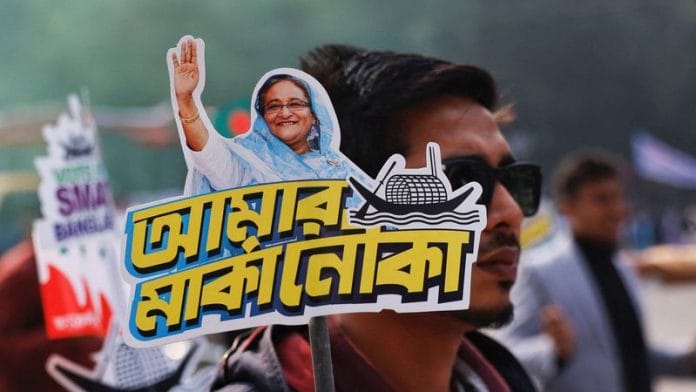 A student holds a placard of Prime Minister Sheikh Hasina as they celebrate the formation day of Bangladesh Chhatra League, the student wing of Bangladesh Awami League, at the University of Dhaka | Reuters