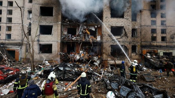 Firefighters work at a site of a residential building heavily damaged during a Russian missile attack in Kyiv, on 2 Jan 2023 | Reuters