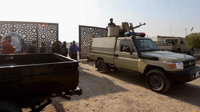 Members of an Iraqi Shi'ite armed group sit in a vehicle after an attack by a drone strike on an Iran-backed militia headquarters in Baghdad, Iraq January 4, 2024 | Reuters