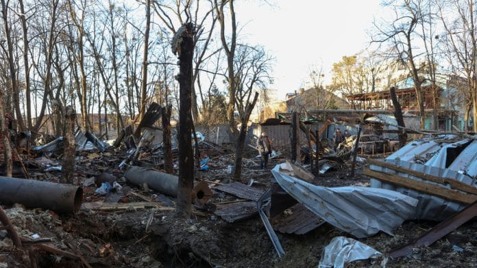 Municipal workers are seen at a site of a Russian drone strike, amid Russia's attack on Ukraine, in Kharkiv, Ukraine December 31, 2023 | Reuters
