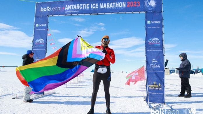 Kunal Bhardwaj waves the pride flag at the 2023 Antarctic Ice Marathon | Photo by special arrangement