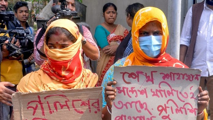 Women show posters during the Sandeshkhali visit of West Bengal Governor C V Ananda Bose (unseen) in North 24 Parganas on Monday | ANI