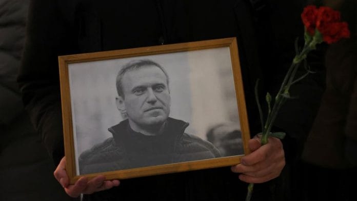 People gather at the Solovetsky Stone monument to the victims of political repressions to honour the memory of Russian opposition leader Alexei Navalny, in Saint Petersburg, Russia February 17, 2024 | Reuters