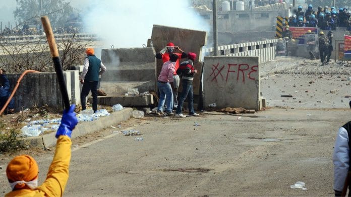 Agitating farmers move away after Haryana Police fire tear gas shells to disperse them as they resume their Delhi Challo March, at the Shambhu border (Punjab-Haryana) in Patiala on Wednesday | ANI