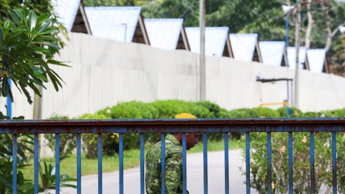 A security guard is stationed at the entrance of an immigration detention centre where more than 100 Myanmar migrants, including Rohingya refugees, escaped, at Bidor, Malaysia February 2, 2024 | Reuters