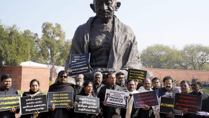 DMK MPs TR Baalu, Kanimozhi and others stage protest at the Gandhi statue against the BJP-led Centre over alleged neglect and partiality in allocation of funds to the states, at the Parliament House complex during the Budget session, in New Delhi, Thursday | PTI Photo/Shahbaz Khan