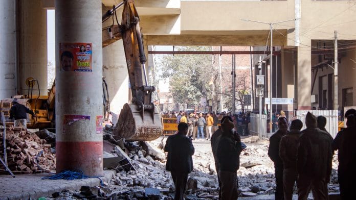 Officials stand near debris after a portion of the Gokulpuri Metro Station on the Pink Line collapsed, in New Delhi, Thursday | PTI