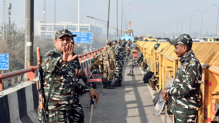 Paramilitary personnel stand guard near the barricaded Ghazipur border in view of farmers' 'Delhi Chalo' protest march | ANI