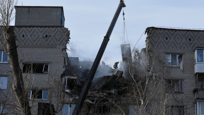 A rescue worker operates at the site of an apartment building damaged by a Russian drone strike, amid Russia's attack on Ukraine, in Dnipro, Ukraine February 23, 2024 | Mykola Synelnykov | Reuters