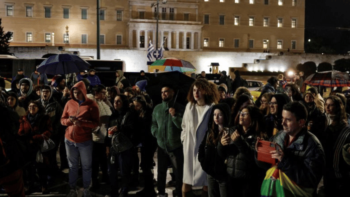 Members of the LGBTQ+ community and supporters watch the end of debate in front of the Greek parliament, ahead of the vote on the bill which legalises same-sex civil marriage, in Athens, Greece, February 15, 2024. REUTERS/Louisa Gouliamaki