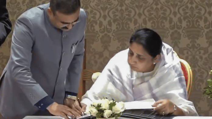 Sunetra Pawar, wife of late NCP chief Ajit Pawar, signs documents after taking oath as Maharashtra's first woman Deputy Chief Minister. | PTI