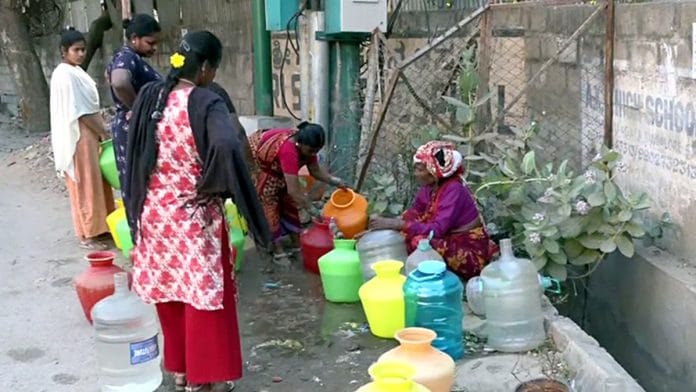People wait for their turn to fill their gallons with running water in Bengaluru | ANI