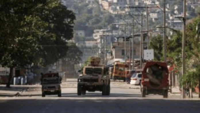 An armed vehicle near the National Penitentiary following violent clashes that have damaged communications and led to a prison escape from this main penitentiary in Port-au-Prince yesterday | Ralph Tedy Erol | Reuters