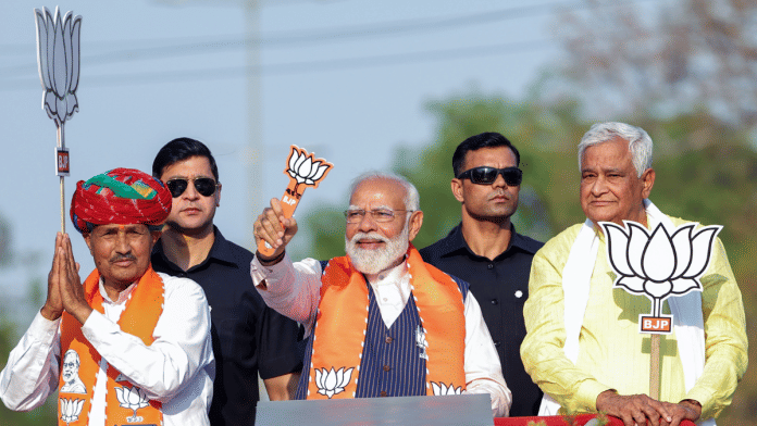 Prime Minister Narendra Modi holds a roadshow for BJP candidate Kanhaiya Lal Meena ahead of the Lok Sabha polls in Dausa, Rajasthan | ANI