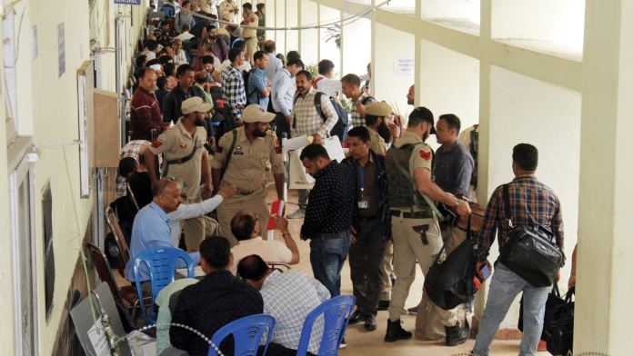 Polling officials carrying EVMs and other materials leave with police personnel on the eve of the first phase of the Lok Sabha elections, in Udhampur | ANI