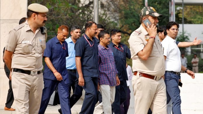 Police officers escort Chief Minister of Delhi and Aam Aadmi Party (AAP) Arvind Kejriwal as he leaves the court after a hearing in New Delhi, India March 28, 2024 | Reuters