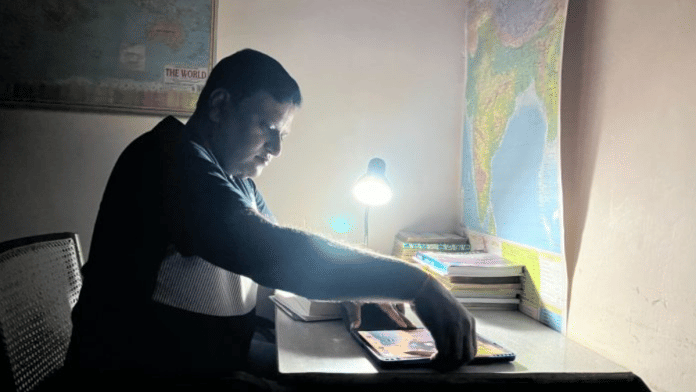Pushpendra Srivastava hunched over his study desk, preparing for the interview | Photo: Nootan Sharma | ThePrint