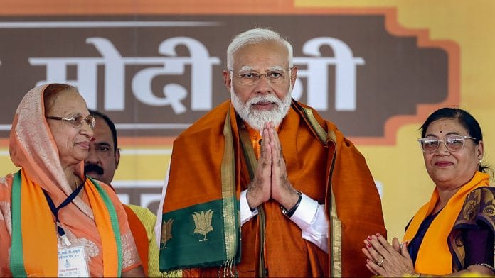 Prime Minister Narendra Modi being welcomed during a public meeting for Lok Sabha polls in Khargone, Tuesday | PTI