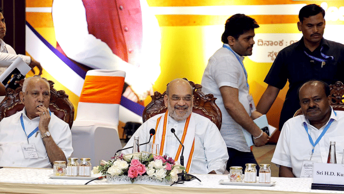 Photo caption: File photo of Union Home Minister Amit Shah with senior Bharatiya Janata Party (BJP) leader B.S. Yediyurappa and Janata Dal (Secular) leader H.D. Kumaraswamy at the BJP-JD(S) committee meeting in Bengaluru | ANI