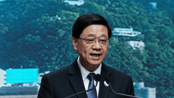 One of the three men accused of aiding intelligence services is said to be a classmate of Hong Kong Chief Executive John Lee (above) | Reuters