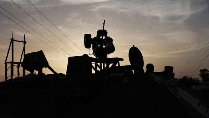 An Israeli solider is silhouetted inside an armored personnel carrier, as military operations continue in the southern Gaza city of Rafah | File photo | Reuters