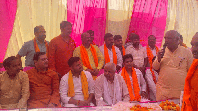 Brij Bhushan Sharan Singh’s son Karan Bhushan looks on as his father’s representative Sanjeev Singh addresses a public meeting in Chandavatpur area of Katra Bazar | Shikha Salaria | ThePrint