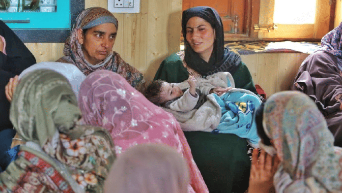 Shabnam Aijaz holds her 4-month-old daughter at her house at Heerpora in Kashmir's Shopian district. Her husband Aijaz Ahmad Sheikh was shot dead by unidentified gunmen on Saturday evening | Praveen Jain | ThePrint
