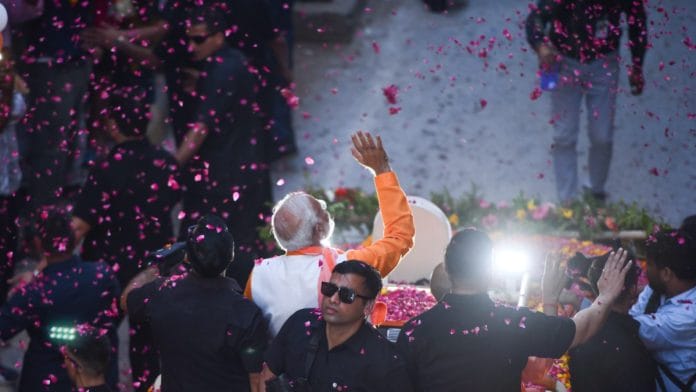 Prime Minister Narendra Modi during a roadshow as a part of his election campaign in Varanasi | Suraj Singh Bisht | ThePrint