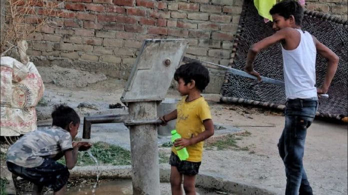 Children drinking water from a handpump in Vidhishyama village, Mall gram panchayat | File Photo: Praveen Jain | ThePrint