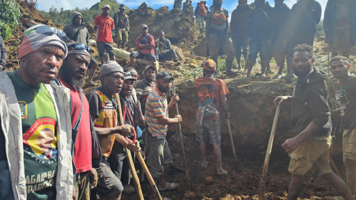 Locals gather amid the damage after a landslide in Maip Mulitaka, Enga province, Papua New Guinea 24 May, 2024 in this obtained image. Emmanuel Eralia via Reuters