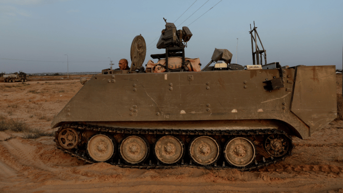 An Israeli solider drives an armored personnel carrier, as military operations continue in the southern Gaza city of Rafah, at an area outside Kerem Shalom, Israel | File Photo | Reuters/Shannon Stapleton