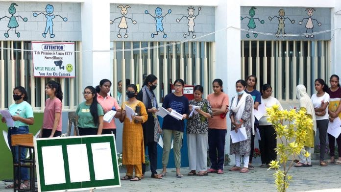 Representational image: NEET aspirants standing in a queue | ANI