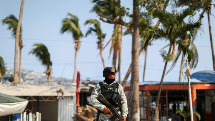 A member of the National Guard stands guard at a crime scene where two people were shot in Acapulco, Mexico in May | Reuters